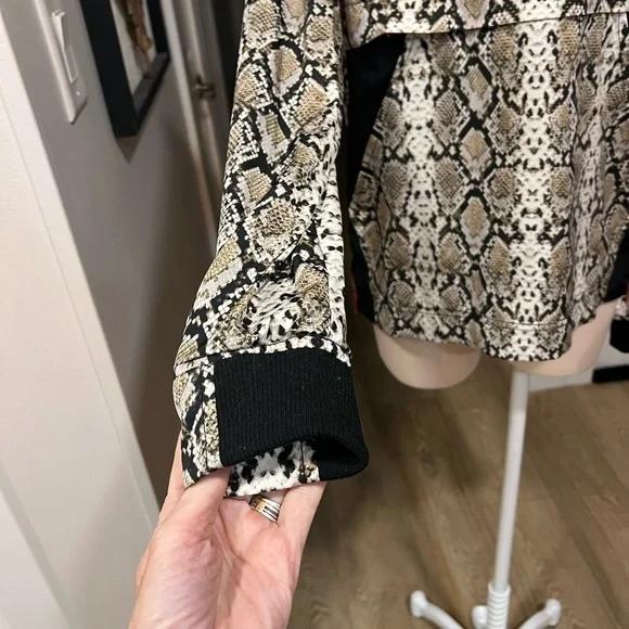 ALALA snakeskin anorak with red accents